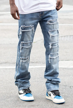 Load image into Gallery viewer, Expertly crafted with a mid high thread count for superior softness and durability, our exclusive Side Raw Edge Rip &amp; Repair Raw Denim Jeans are a must-have for any wardrobe. The slim fit and comfort-stretched denim offer both style and comfort, while the distressed details and raw edges add a touch of edge to any look. Made with 97% cotton and 3% spandex, these indigo blue jeans are the perfect addition to your wardrobe.
